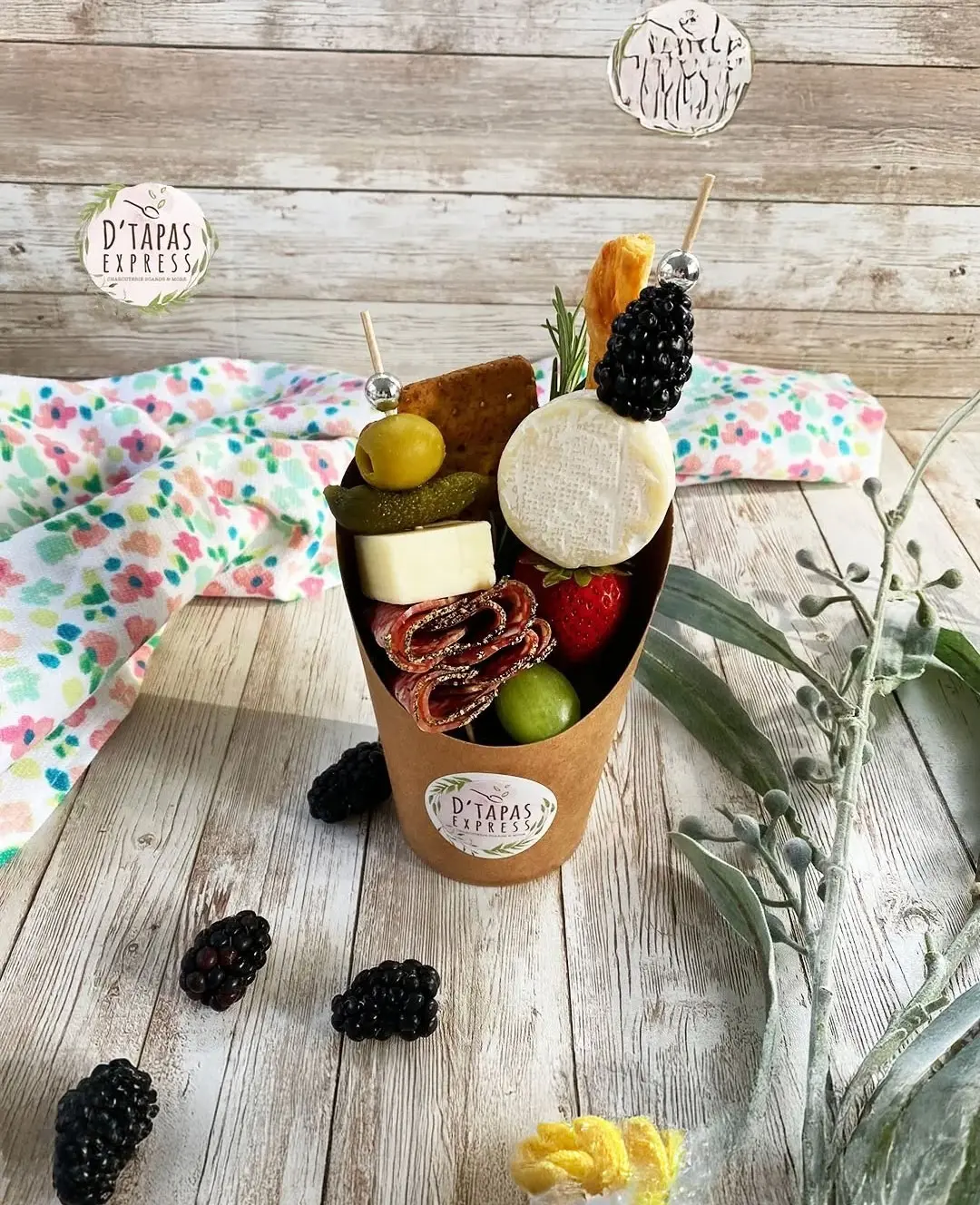 Grazing Cups & Cones: Individual portions ready to enjoy or gift. Minimum order of 10. Cup contents may vary based on customer preference and availability. Includes 2 types of cheeses, 1 cured meat, fresh fruit, nuts, crackers, and a sweet treat.